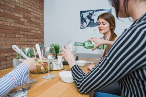 Woman Pouring White Wine In Glass